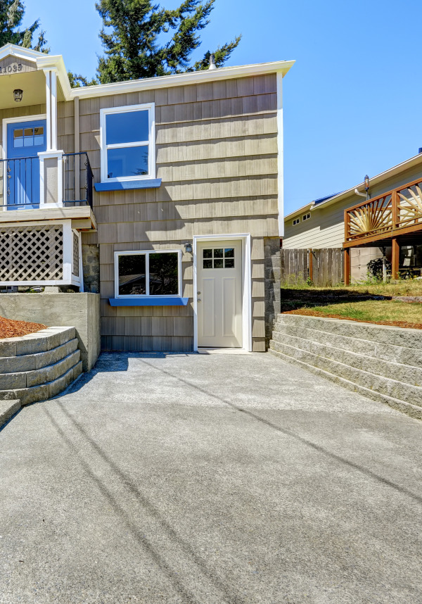 Asphalt driveway with stone walls